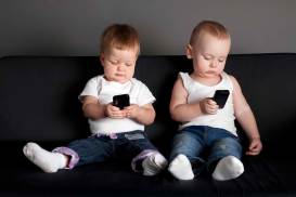 little-boy-and-girl-playing-with-mobile-phones